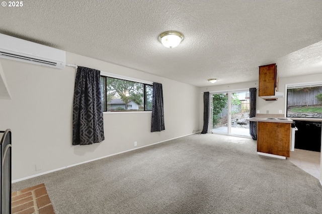 unfurnished living room with baseboards, light carpet, an AC wall unit, and a textured ceiling