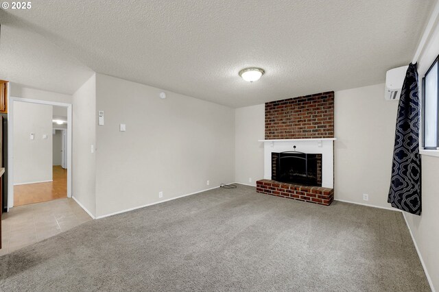 unfurnished living room featuring light carpet, a fireplace, a wall mounted air conditioner, a textured ceiling, and baseboards