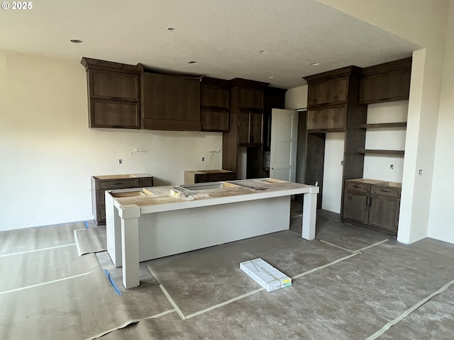 kitchen featuring dark brown cabinets and a breakfast bar area