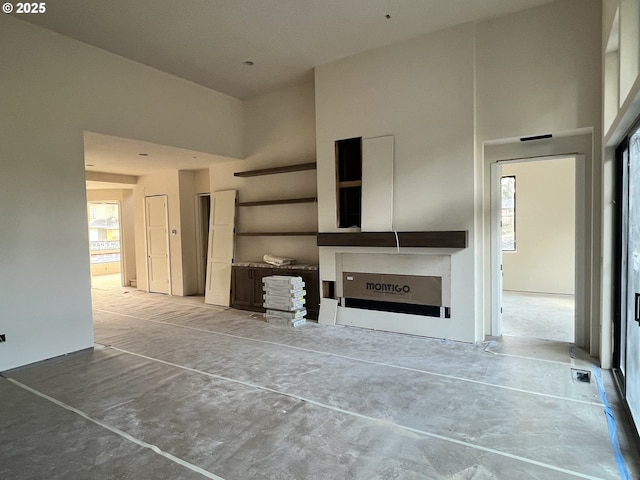 unfurnished living room with a high ceiling