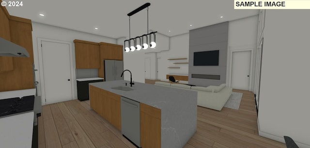 kitchen featuring decorative light fixtures, an island with sink, light hardwood / wood-style floors, sink, and white dishwasher