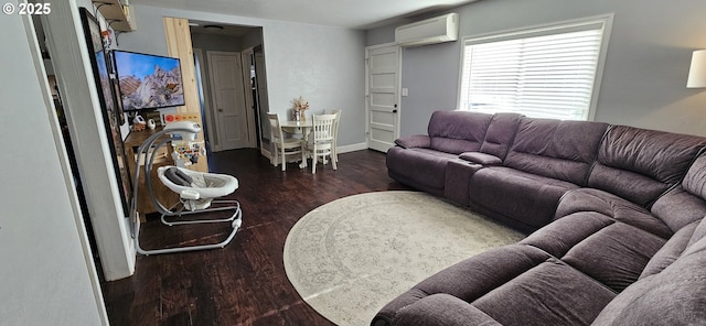 living room with dark hardwood / wood-style floors and a wall unit AC