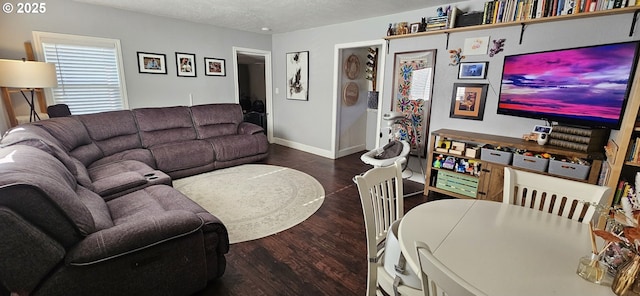 living room featuring dark hardwood / wood-style flooring and a textured ceiling