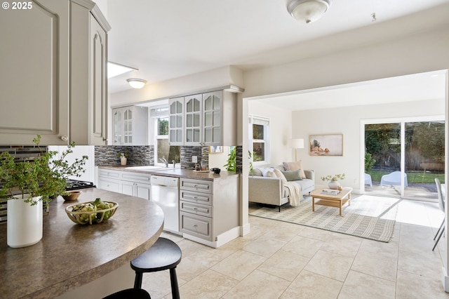 4770 SW Beech Dr, Beaverton, OR 97005 - kitchen featuring white dishwasher, backsplash, gray cabinetry, and glass insert cabinets