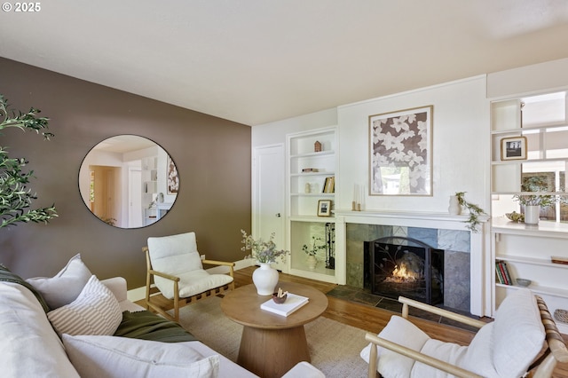 4770 SW Beech Dr, Beaverton, OR 97005 - living room with wood finished floors, a fireplace, baseboards, and built in shelves
