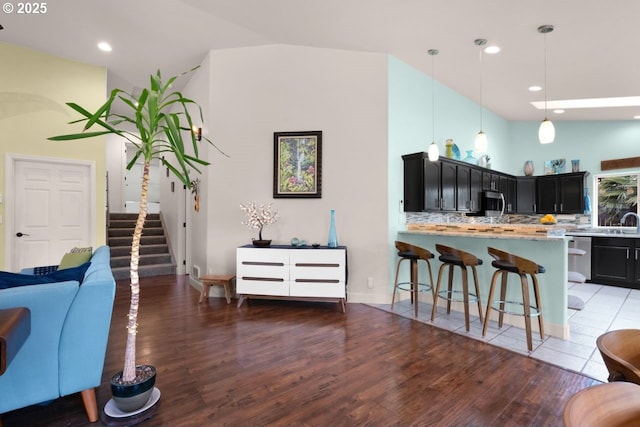 3275 Redwood Loop, Florence, OR 97439 - living room featuring light wood-type flooring, stairway, and recessed lighting