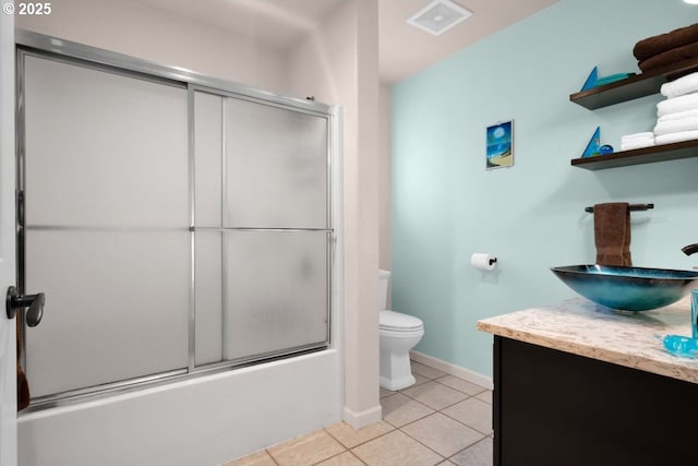3275 Redwood Loop, Florence, OR 97439 - bathroom with vanity, toilet, tile patterned floors, bath / shower combo with glass door, and baseboards