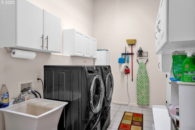 3275 Redwood Loop, Florence, OR 97439 - laundry area featuring washer and dryer, light tile patterned floors, baseboards, and cabinet space