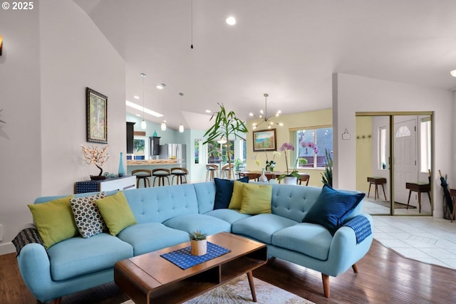 3275 Redwood Loop, Florence, OR 97439 - living room featuring vaulted ceiling, wood finished floors, a chandelier, and recessed lighting