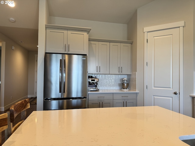 987 Farmington Dr, Junction City, OR 97448 - kitchen with stainless steel refrigerator, gray cabinetry, decorative backsplash, and light stone countertops