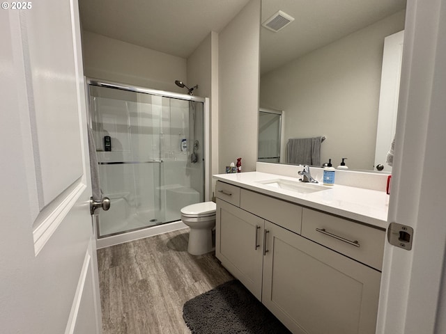 987 Farmington Dr, Junction City, OR 97448 - bathroom with wood finished floors, a shower stall, vanity, and toilet