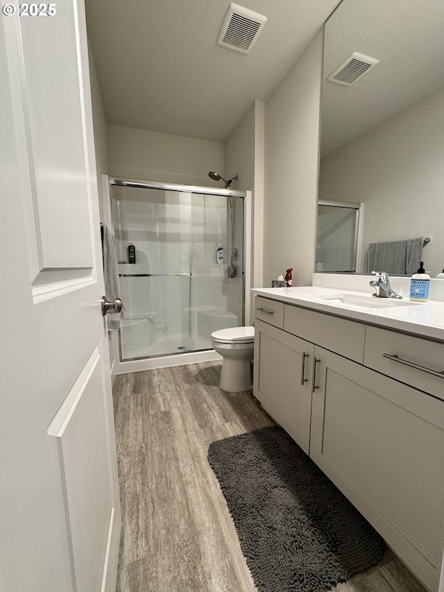 987 Farmington Dr, Junction City, OR 97448 - full bath with wood finished floors, a stall shower, toilet, and vanity