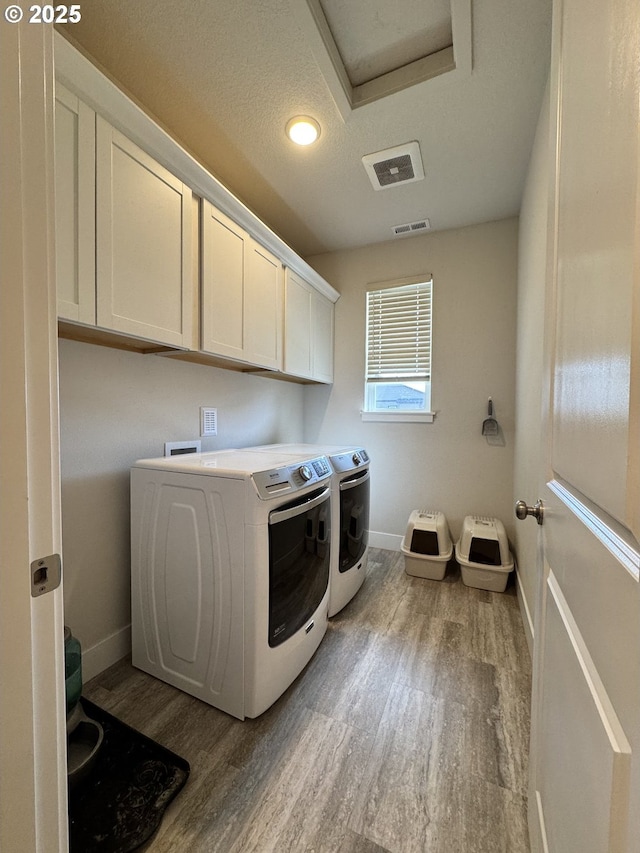 987 Farmington Dr, Junction City, OR 97448 - laundry room featuring wood finished floors, cabinet space, separate washer and dryer, and baseboards