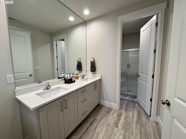 987 Farmington Dr, Junction City, OR 97448 - full bathroom featuring wood finished floors, recessed lighting, a stall shower, double vanity, and baseboards
