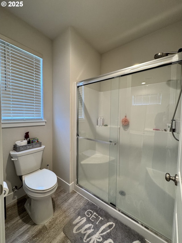 987 Farmington Dr, Junction City, OR 97448 - bathroom featuring wood finished floors, toilet, a shower stall, and baseboards