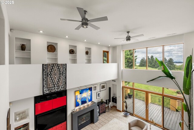 88369 Timberline Dr, Veneta, OR 97487 - living room featuring a ceiling fan, a glass covered fireplace, and recessed lighting