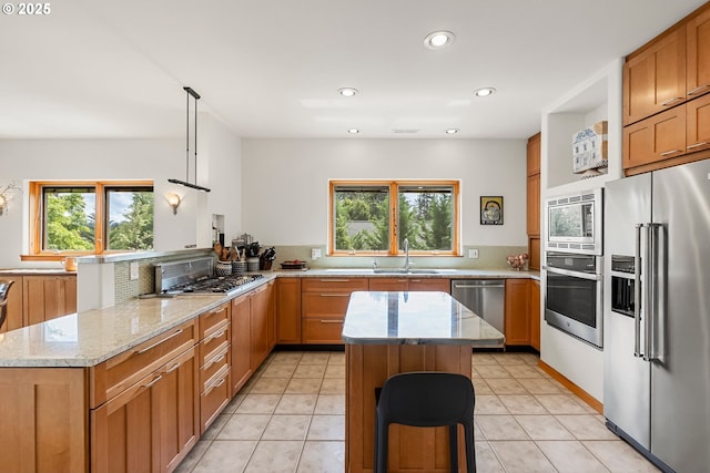 88369 Timberline Dr, Veneta, OR 97487 - kitchen featuring a sink, recessed lighting, backsplash, light stone countertops, and appliances with stainless steel finishes