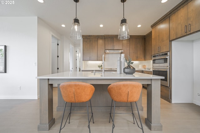 4308 N 12th Way, Ridgefield, WA 98642 - kitchen featuring double oven, recessed lighting, decorative backsplash, light countertops, and brown cabinets