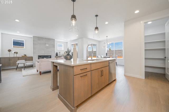 4308 N 12th Way, Ridgefield, WA 98642 - kitchen featuring dishwasher, recessed lighting, light wood-style flooring, light countertops, and a tiled fireplace