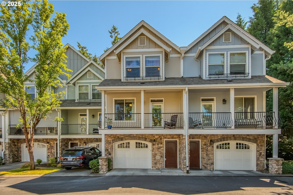 view of front facade featuring a garage, board and batten siding, and a shingled roof