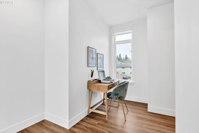 office with a healthy amount of sunlight and wood-type flooring