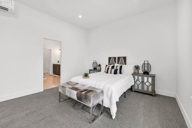 carpeted bedroom with ensuite bathroom and a wall unit AC