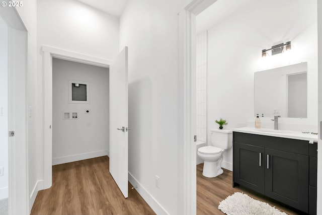 bathroom featuring vanity, toilet, and wood-type flooring