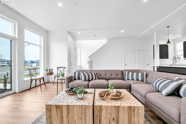 living room with sink and light wood-type flooring