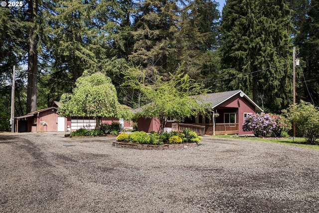 27539 Kingsley Rd, Scappoose, OR 97056 - view of property hidden behind natural elements with driveway, a porch, and a garage