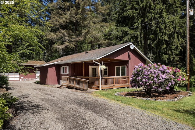 27539 Kingsley Rd, Scappoose, OR 97056 - view of front of house with covered porch, gravel driveway, and roof with shingles