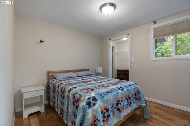 27539 Kingsley Rd, Scappoose, OR 97056 - bedroom featuring wood finished floors, baseboards, and a walk in closet