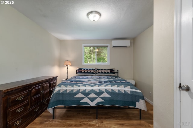 27539 Kingsley Rd, Scappoose, OR 97056 - bedroom featuring a wall mounted air conditioner and wood finished floors