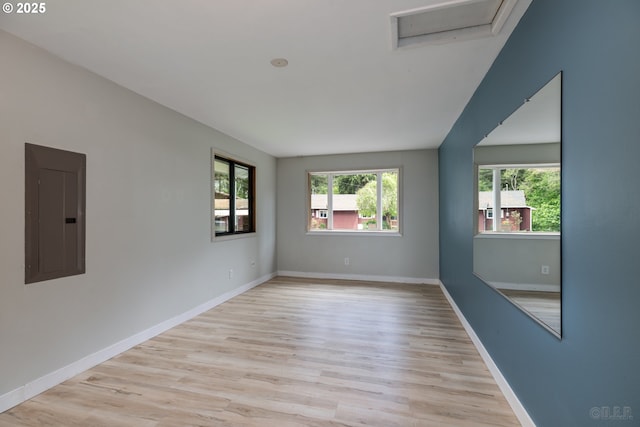 27539 Kingsley Rd, Scappoose, OR 97056 - empty room featuring electric panel, wood finished floors, baseboards, and attic access