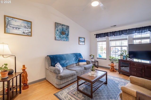 living room with lofted ceiling and light wood-type flooring