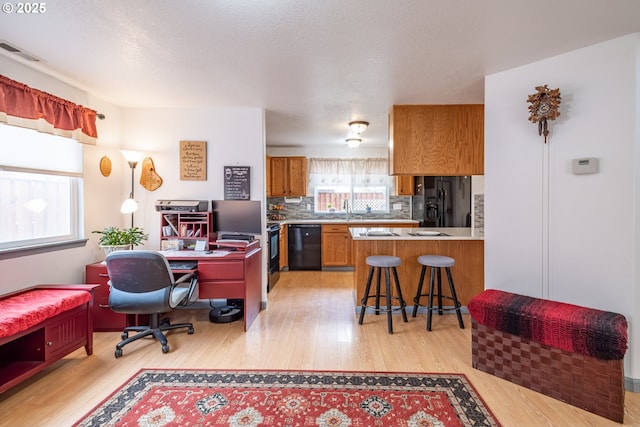 office area with sink and light hardwood / wood-style floors