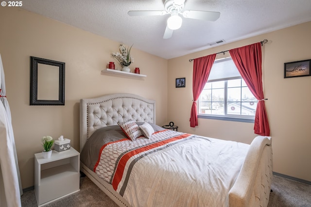 carpeted bedroom with ceiling fan and a textured ceiling