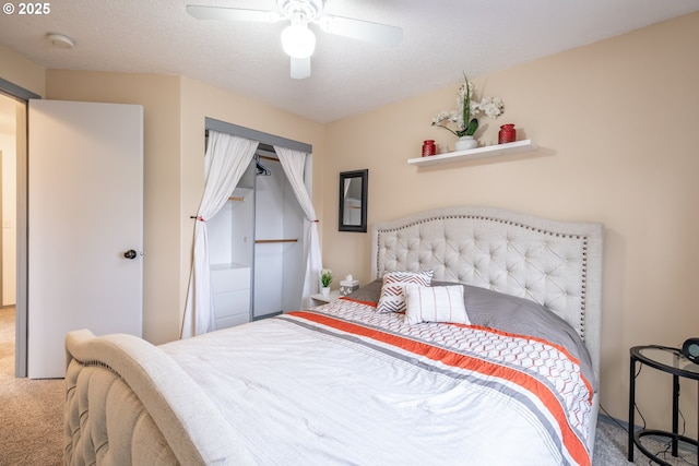 bedroom featuring carpet, a textured ceiling, and ceiling fan