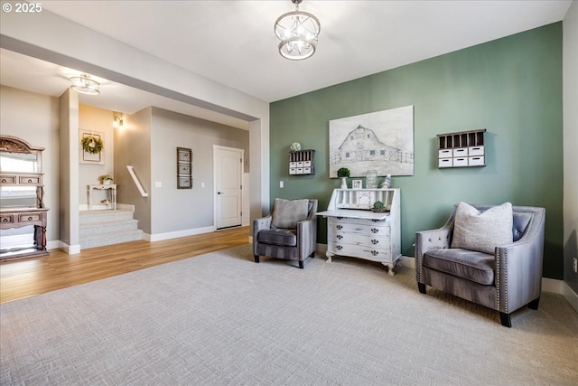 sitting room with a notable chandelier and light hardwood / wood-style flooring