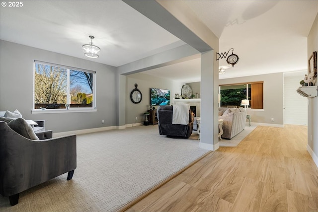 living room featuring a notable chandelier and light wood-type flooring