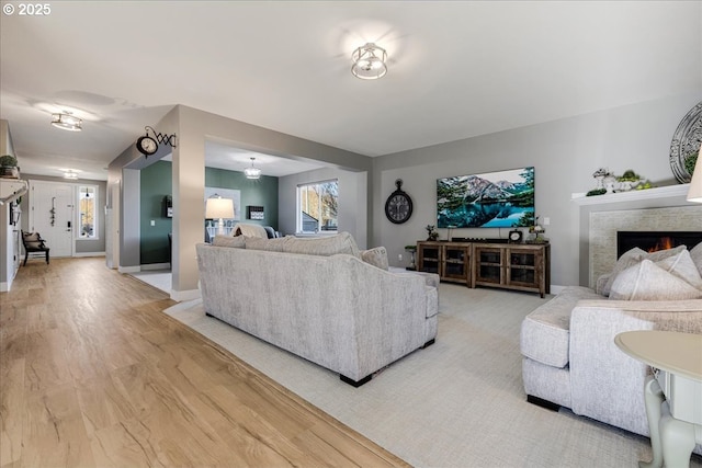 living room with light wood-type flooring and a healthy amount of sunlight