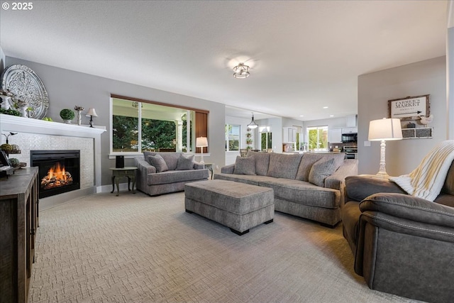 living room with a fireplace and light colored carpet