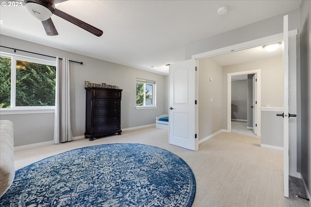 bedroom with ceiling fan and light colored carpet