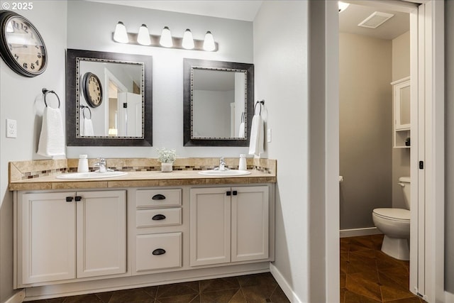 bathroom featuring tile patterned floors, toilet, and vanity