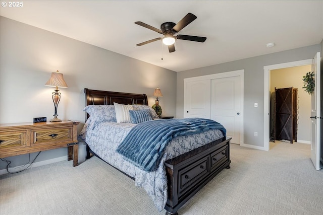 bedroom featuring light carpet, a closet, and ceiling fan