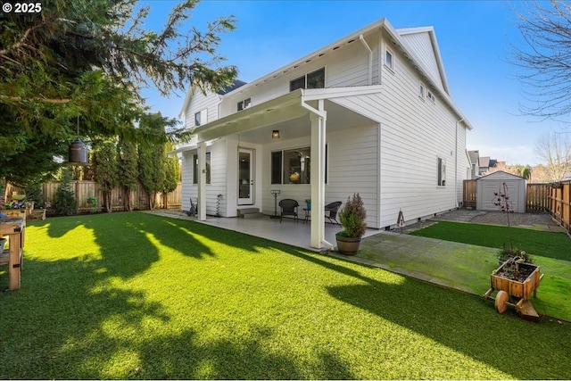 rear view of house featuring a storage unit, a patio area, and a yard