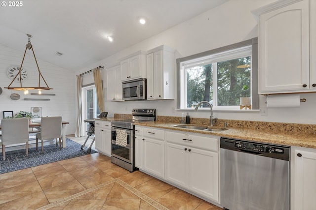 kitchen featuring recessed lighting, appliances with stainless steel finishes, white cabinets, vaulted ceiling, and a sink