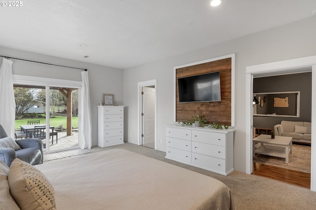 bedroom with recessed lighting, access to outside, connected bathroom, and light colored carpet