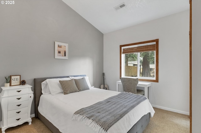 bedroom with lofted ceiling, light carpet, visible vents, and baseboards