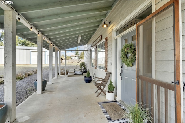 view of patio / terrace featuring an outdoor structure and fence