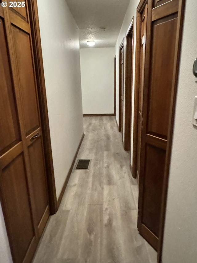15400 SE Barlow Ct, Damascus, OR 97089 - hallway featuring light wood-style floors and baseboards